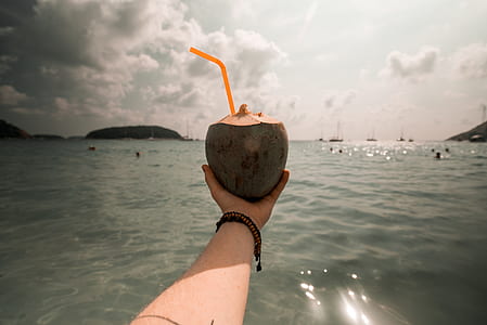 person holding green coconut thumbnail