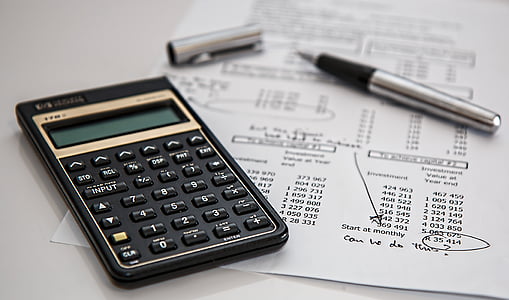 black desk calculator and gel pen on table thumbnail