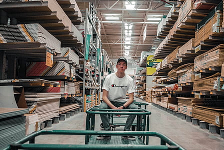 man sitting on green metal frame inside room thumbnail