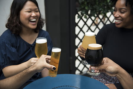 Women Laughing Holding Glass Of Drinks thumbnail
