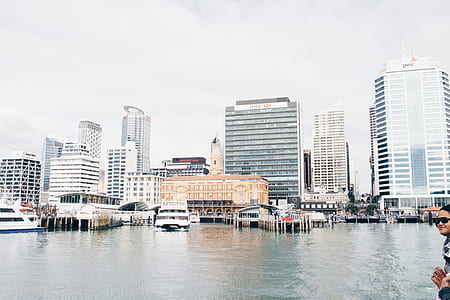 assorted-color high rise building near body of water during daytime thumbnail