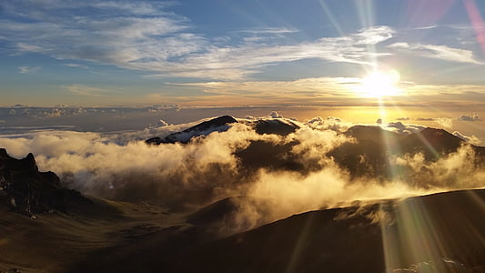 photo of mountain under white clouds at noontime thumbnail