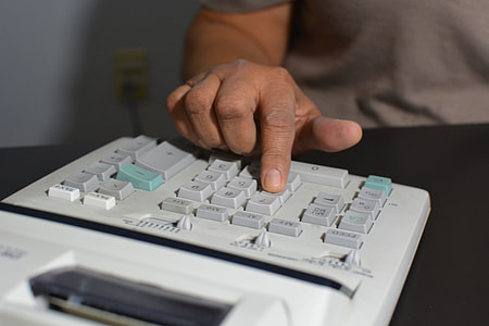 person touching gray and white calculator thumbnail