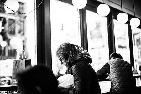 gray scale photography of people staying inside the shop thumbnail