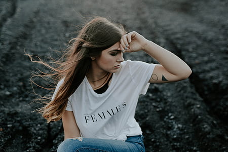 woman wearing white shirt holding her head thumbnail