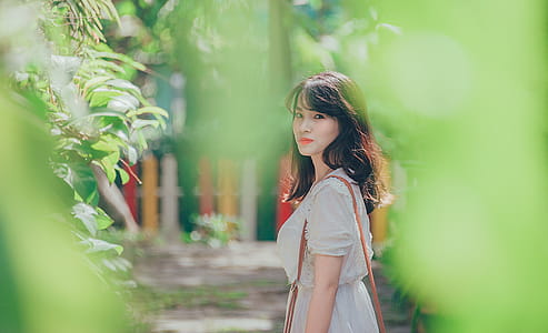 Woman Wearing White Dress With Sling Bag thumbnail