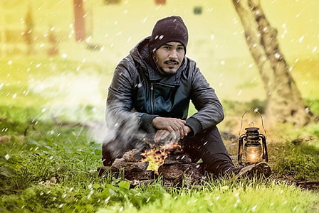 man sitting on green grassland thumbnail