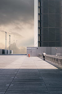 person walking toward building thumbnail
