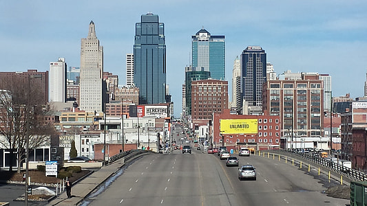 cars on road fronting buildings thumbnail