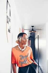 woman standing on white hall way thumbnail