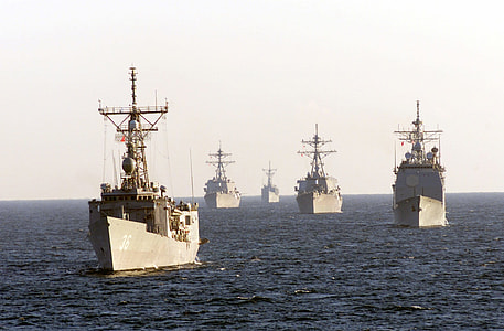 five brown fighting ships on sea thumbnail