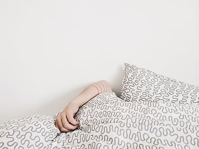 person holding white-and-gray textile thumbnail