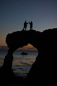 silhouette of couple on top of arch thumbnail