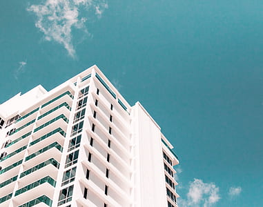 white building under blue sky thumbnail