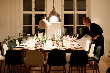 woman arranging the dining table thumbnail