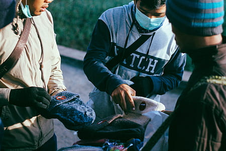 two men picking a hat at daytime thumbnail