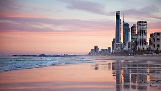 Tall City Buildings Near Beach Shore during Sunset thumbnail