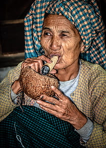 woman holding brown tobacco and brown coconut thumbnail