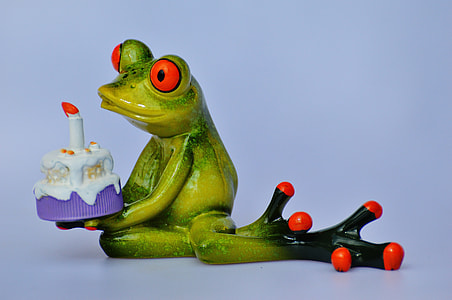 green frog holding cake figurine thumbnail