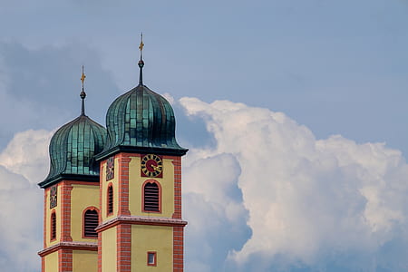 low angle photography of mosque under cumulus clouds thumbnail