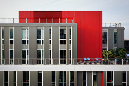 gray and red concrete building near on balcony during daytime thumbnail