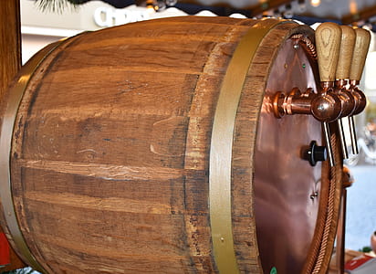 brown beer barrel with beverage dispenser on wooden surface thumbnail