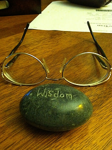brass frame eyeglasses in front of stone with Wisdom text thumbnail