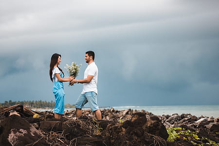 Photo of Man Giving Flowers to Woman thumbnail