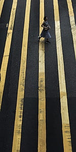 woman walking on black and yellow floor thumbnail