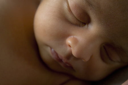 sleeping baby in closeup photograph thumbnail