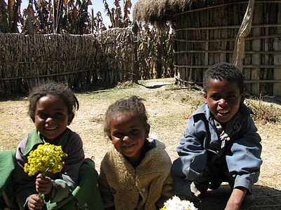 three children sitting on ground thumbnail