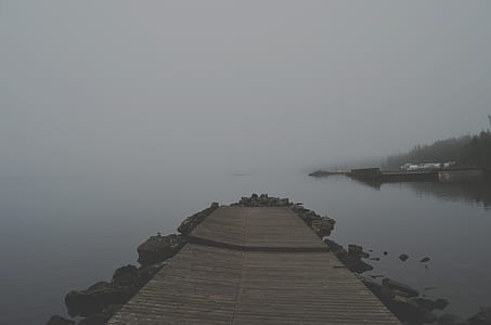 brown wooden dock on water with fogs thumbnail