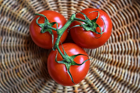 three tomatoes on brown wicker basket thumbnail