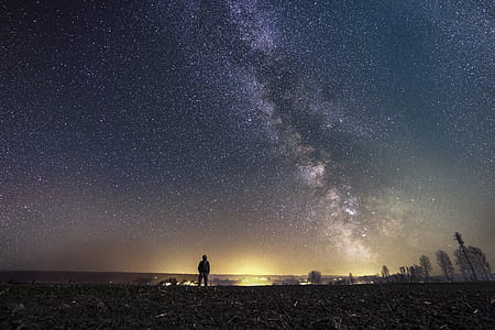 man on seashore under white stars nighttime thumbnail