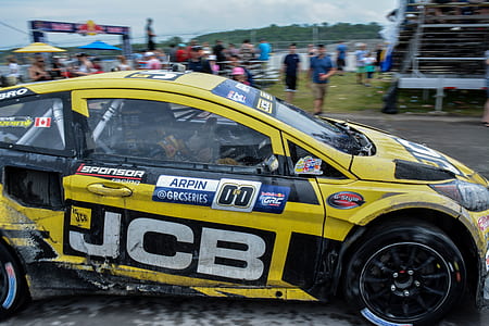 yellow and black racing car park on grey field thumbnail