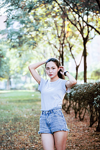 woman standing near green plant under tree at daytime thumbnail