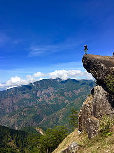 person standing on ledge of rock thumbnail