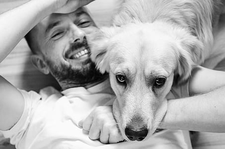 grayscale photo of man with dog thumbnail