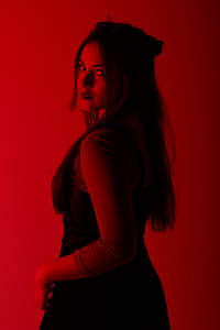 woman wearing black dress with red background thumbnail