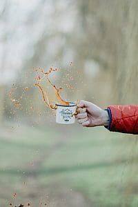 person holding white and blue ceramic mug thumbnail