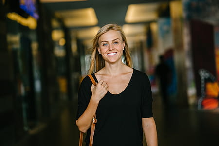 Woman in Black Scoop-neck Top Standing Indoor thumbnail