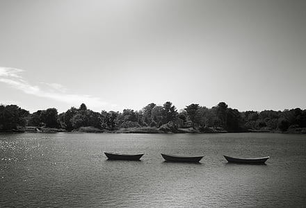 grayscale photography of three boats on body of water thumbnail