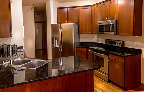 side-by-side refrigerator near brown wooden kitchen cupboards thumbnail