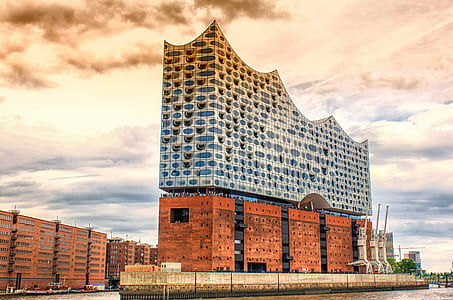 brown and gray concrete building surrounded by water thumbnail