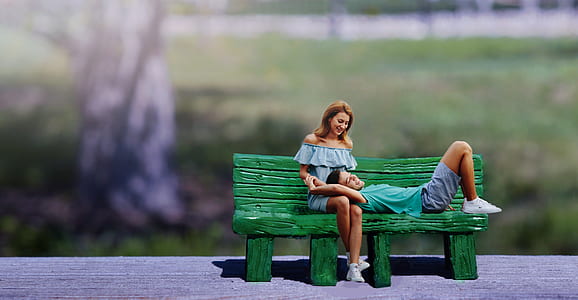 man lying on woman's lap on bench thumbnail