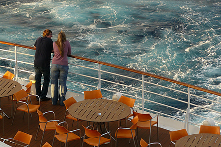 man and woman standing near body of water thumbnail