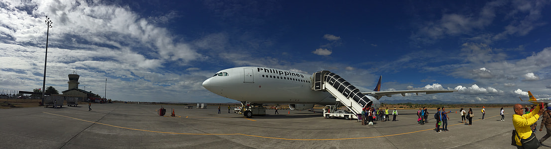 people near white airplane in panoramic photography thumbnail