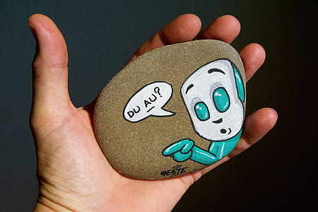 person holding decorative stone thumbnail