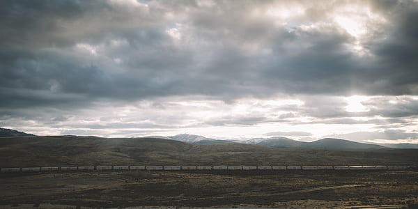 bird's-eye view of mountain under cloudy sky thumbnail