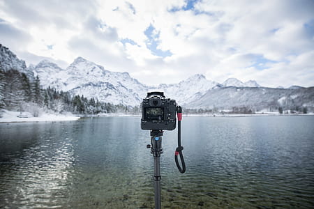 photograph of camera in front of body of water thumbnail